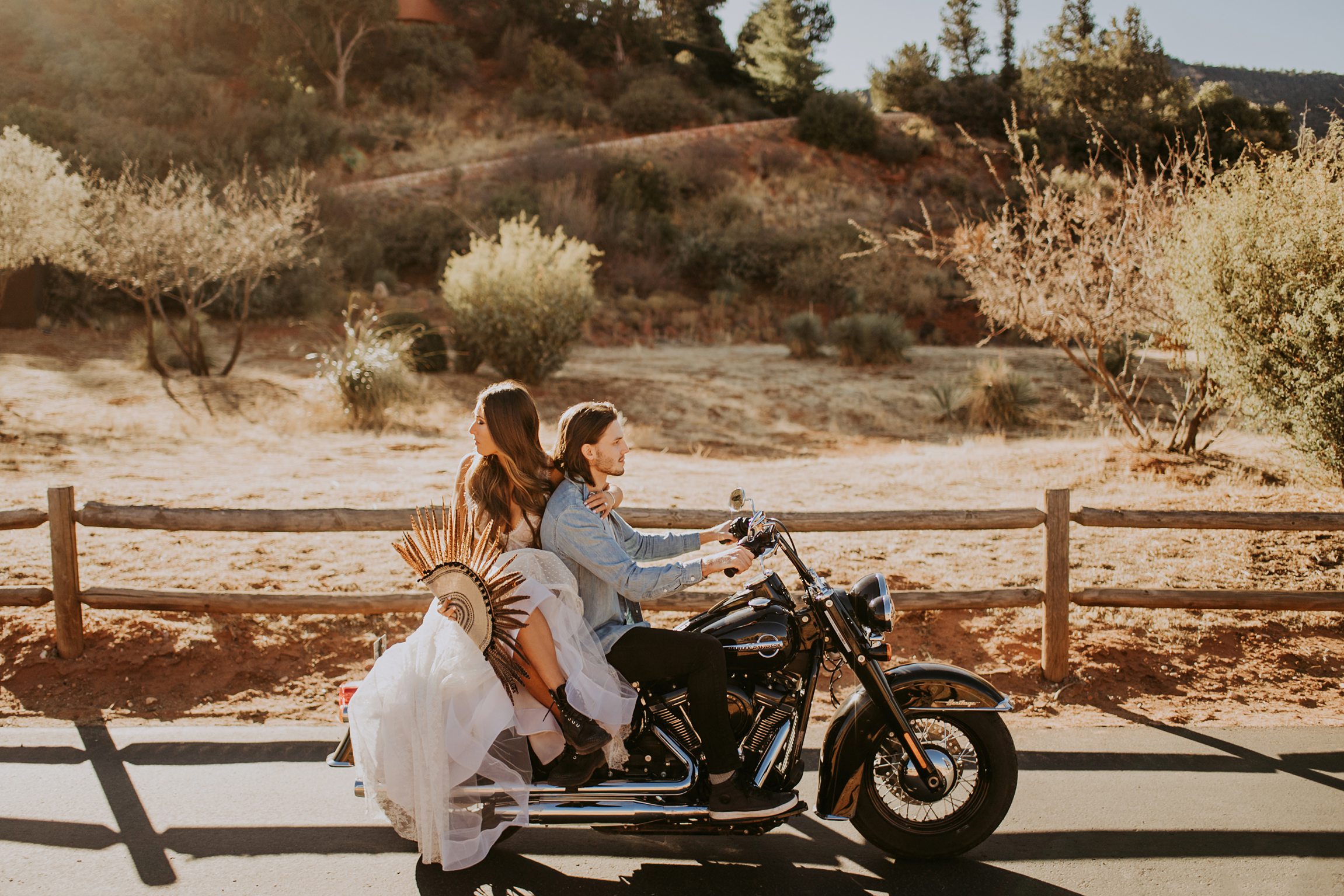 Engagement in Sedona AZ, Elopement in Sedona, Bride and Groom, Harley Davidson Motorcycle, Le Laurier Bridal, Adventurous Elopement, Arizona Wedding Photographer, Engaged, feather fan